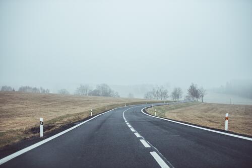 A paved road in the fog