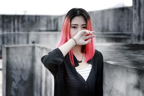 Beautiful girl with Asian looks and pink hair