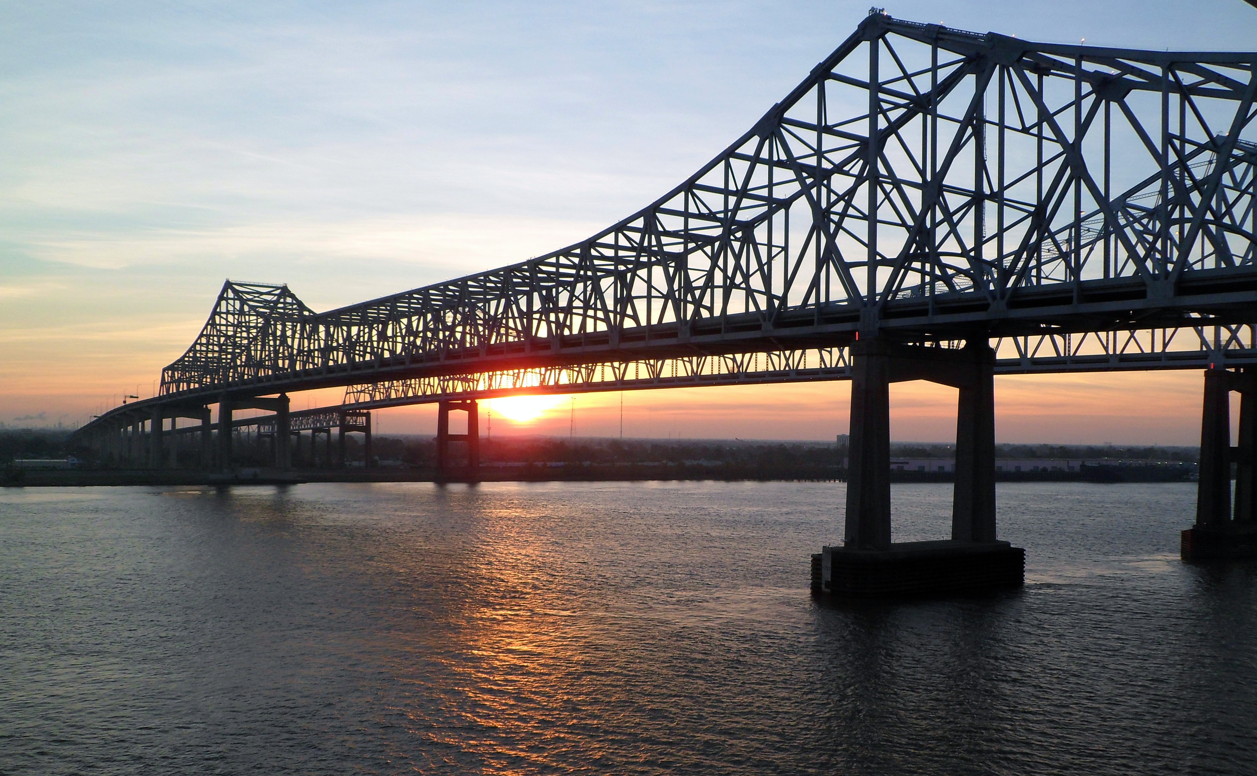 Закат солнца на мосту соединяющего два берега залива моря