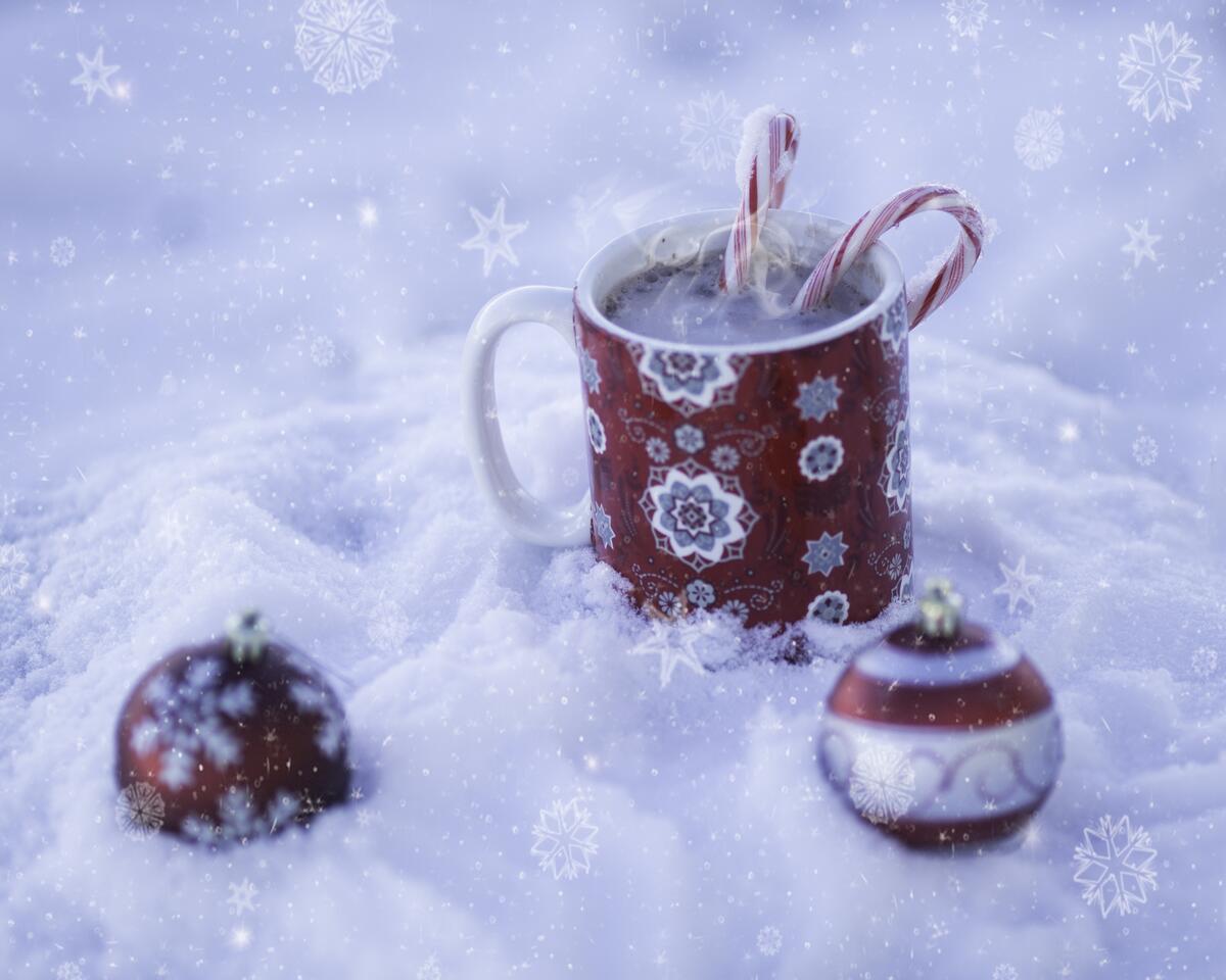 New Year`s mug with hot chocolate in the snow