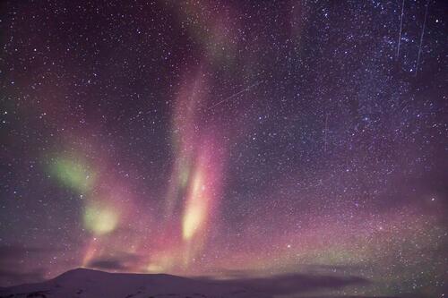 Northern Lights in the night sky with stars