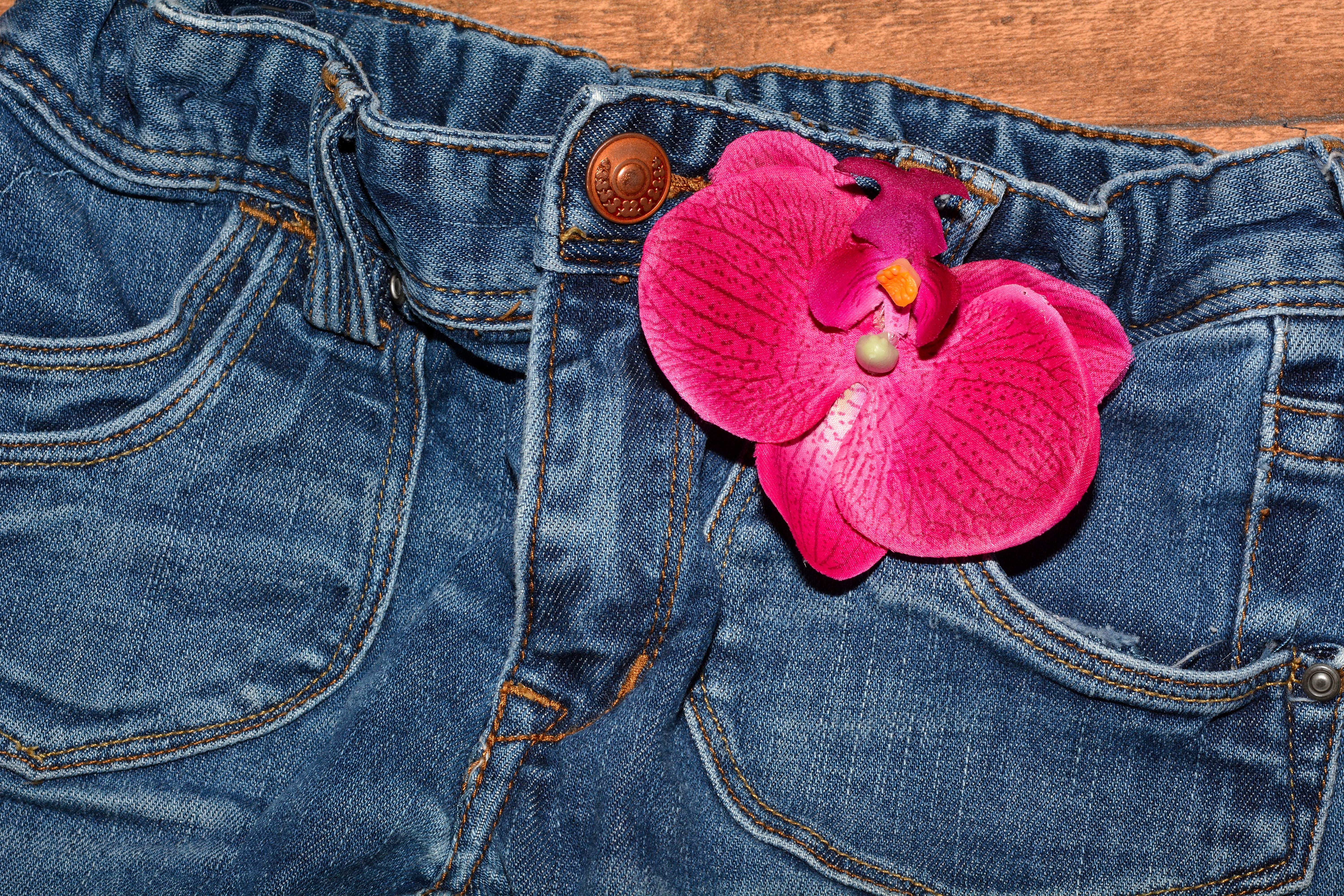 Pink orchid on jeans