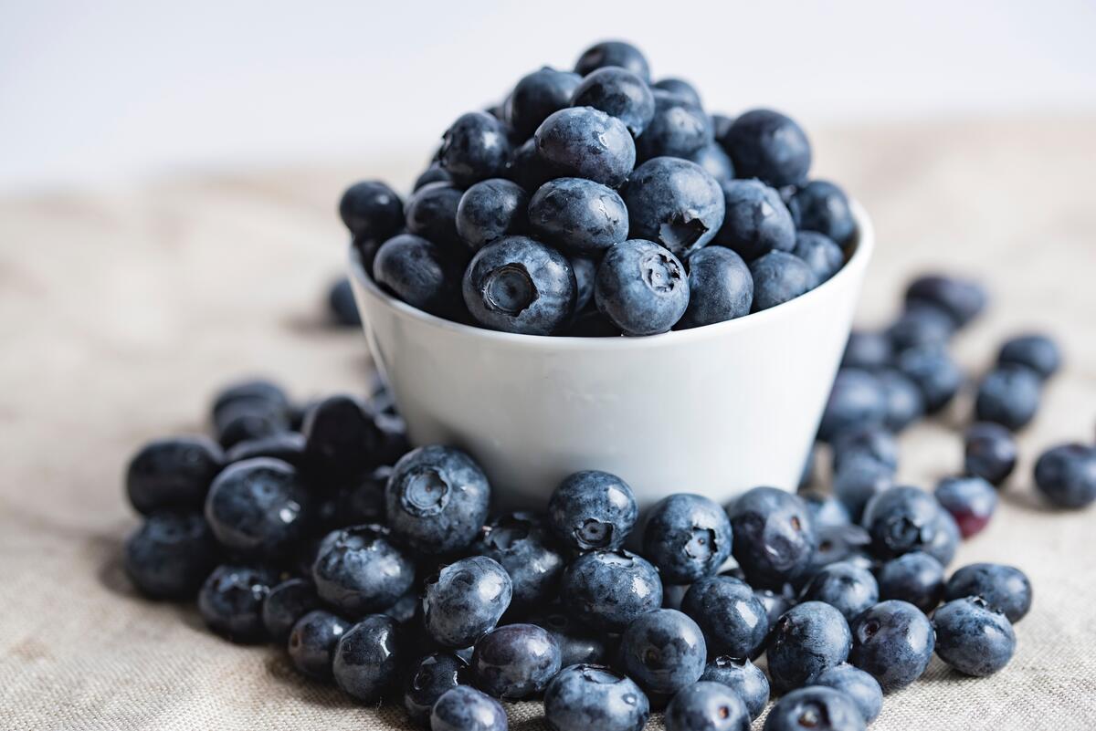 A white bowl of blueberries