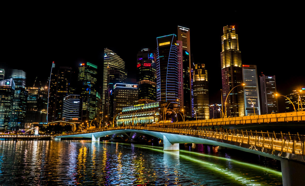 Night illuminated city with the bridge over the strait
