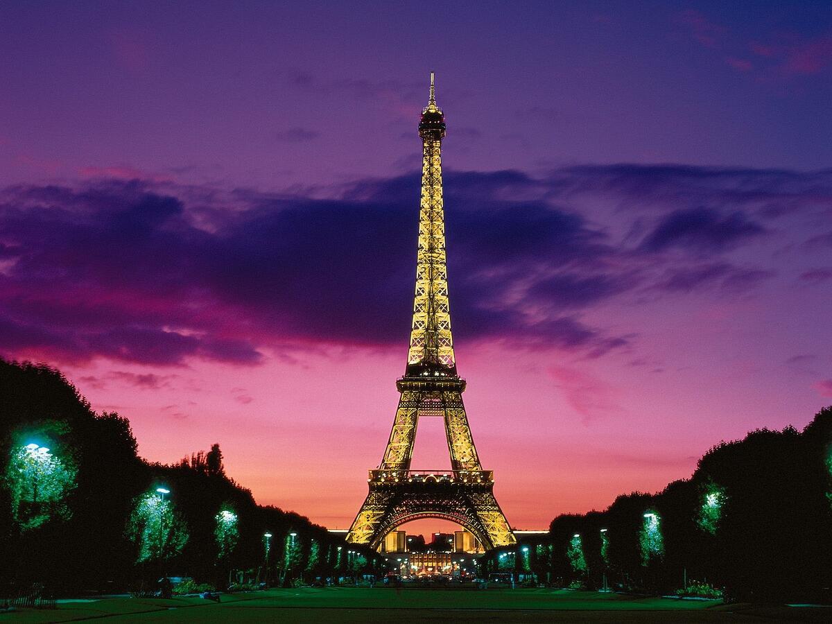 The evening avenue leads to the Eiffel Tower