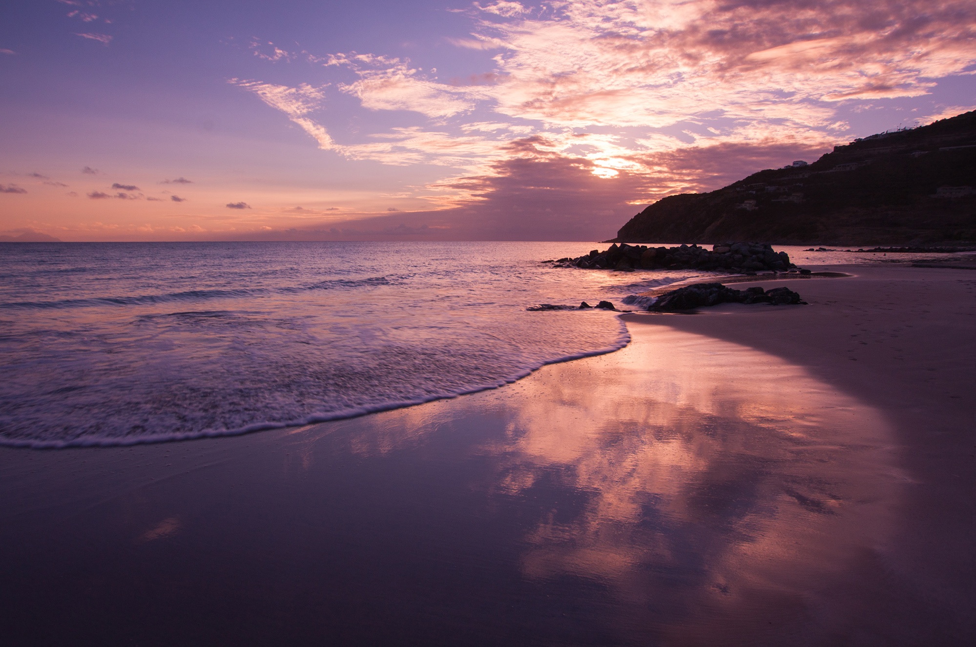 Morning sunrise on the sandy beach of the sea