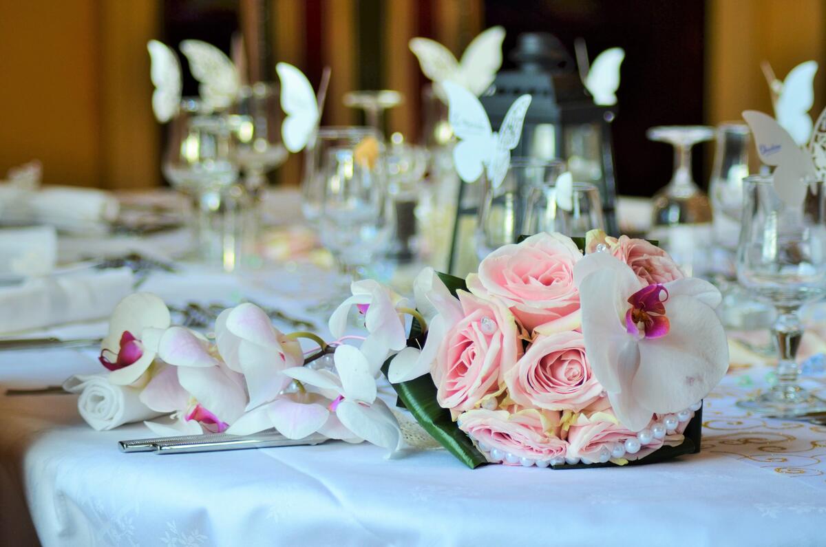 A wedding bouquet of flowers lies on a set table