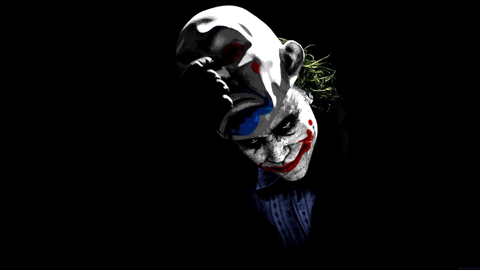 Free photo The Joker takes off his clown mask.