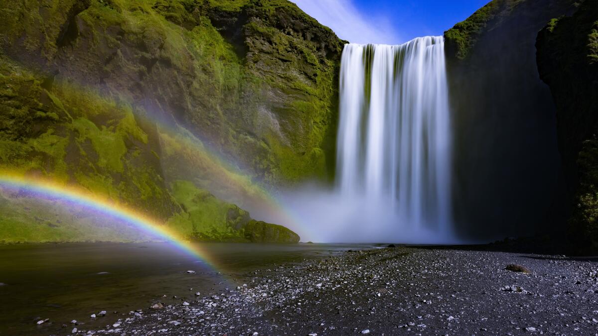 The beautiful Seljalandsfoss waterfall in Iceland with a rainbow