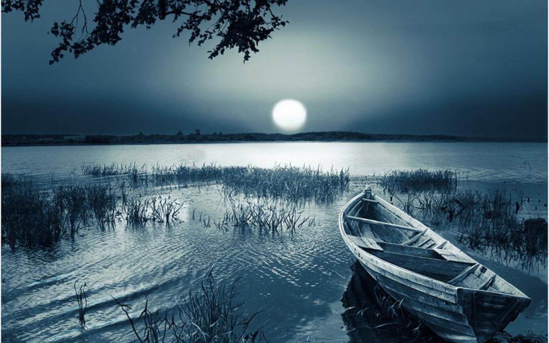 A picture of a lone boat on a lake in the darkness.
