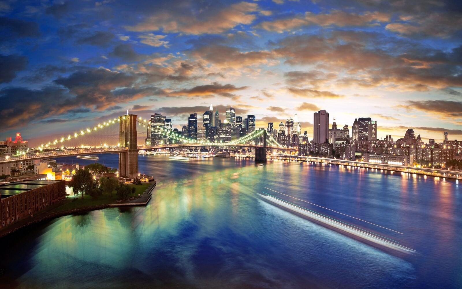 Бесплатное фото Ночной мост через море соединяющий два города