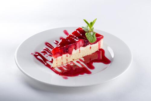 Strawberry cheesecake drizzled with strawberry syrup