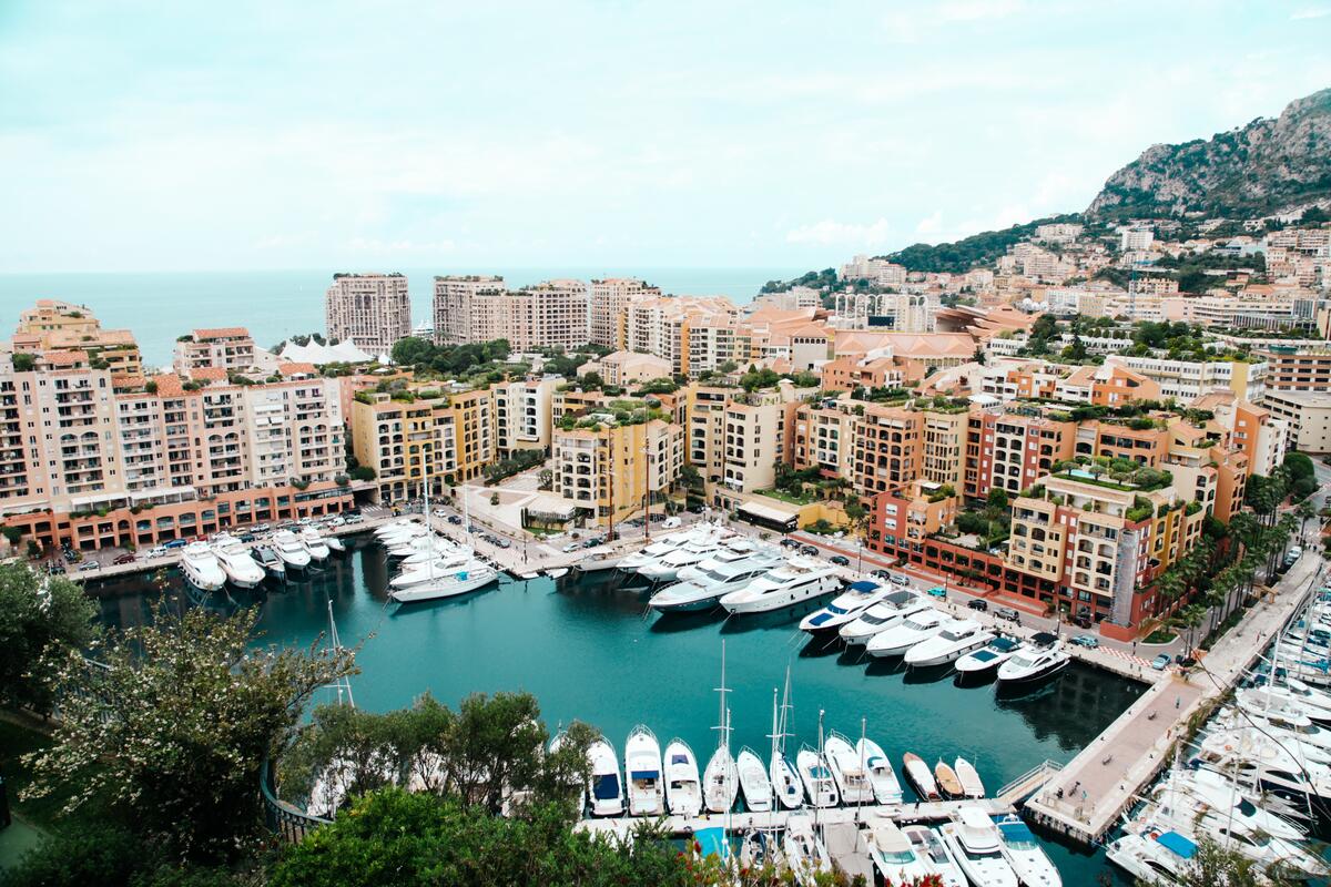 A city on the seashore with a marina and yachts
