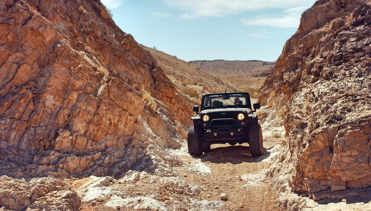 Jeep Wrangler in rocky terrain.