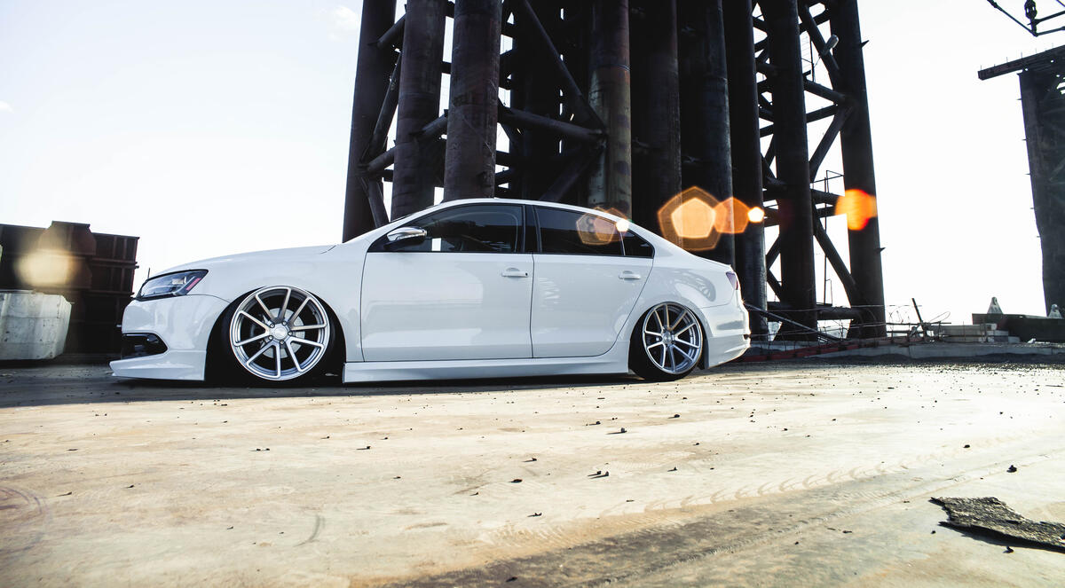 Volkswagen Polo sedan 6 in white on steep rims with underslung side view