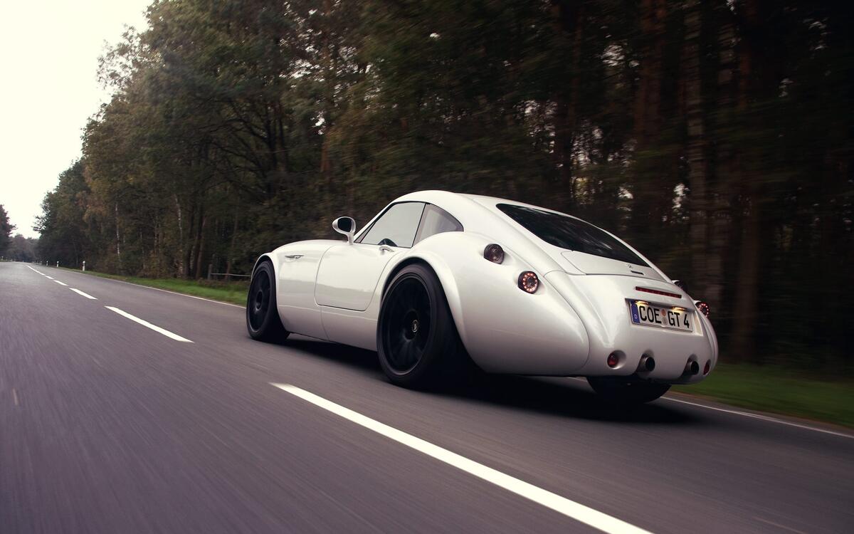 TVR Sagaris driving on a country highway rear view