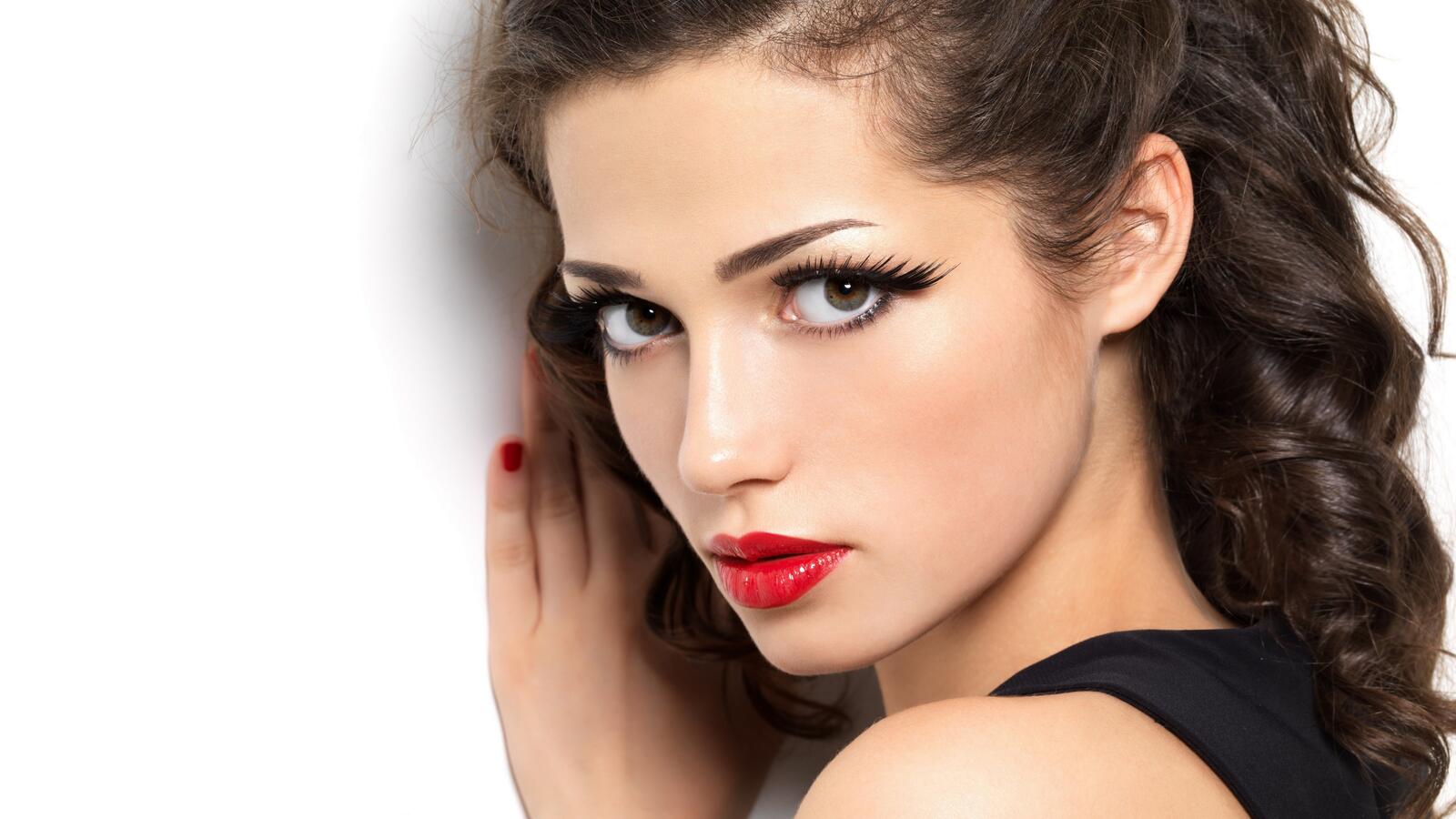 Free photo Portrait of a dark-haired girl with red lipstick on her lips