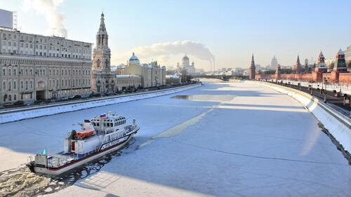 A motorboat of the Ministry of Emergency Situations is driving along the frozen Moskva River