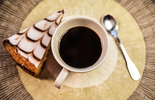 A piece of cake with a cup of coffee.