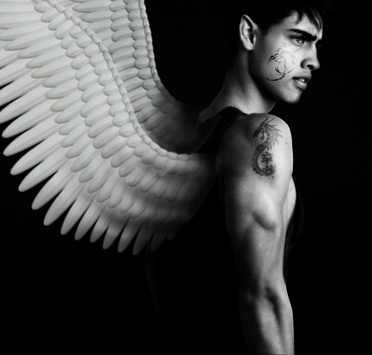Muscular young guy with angel wings