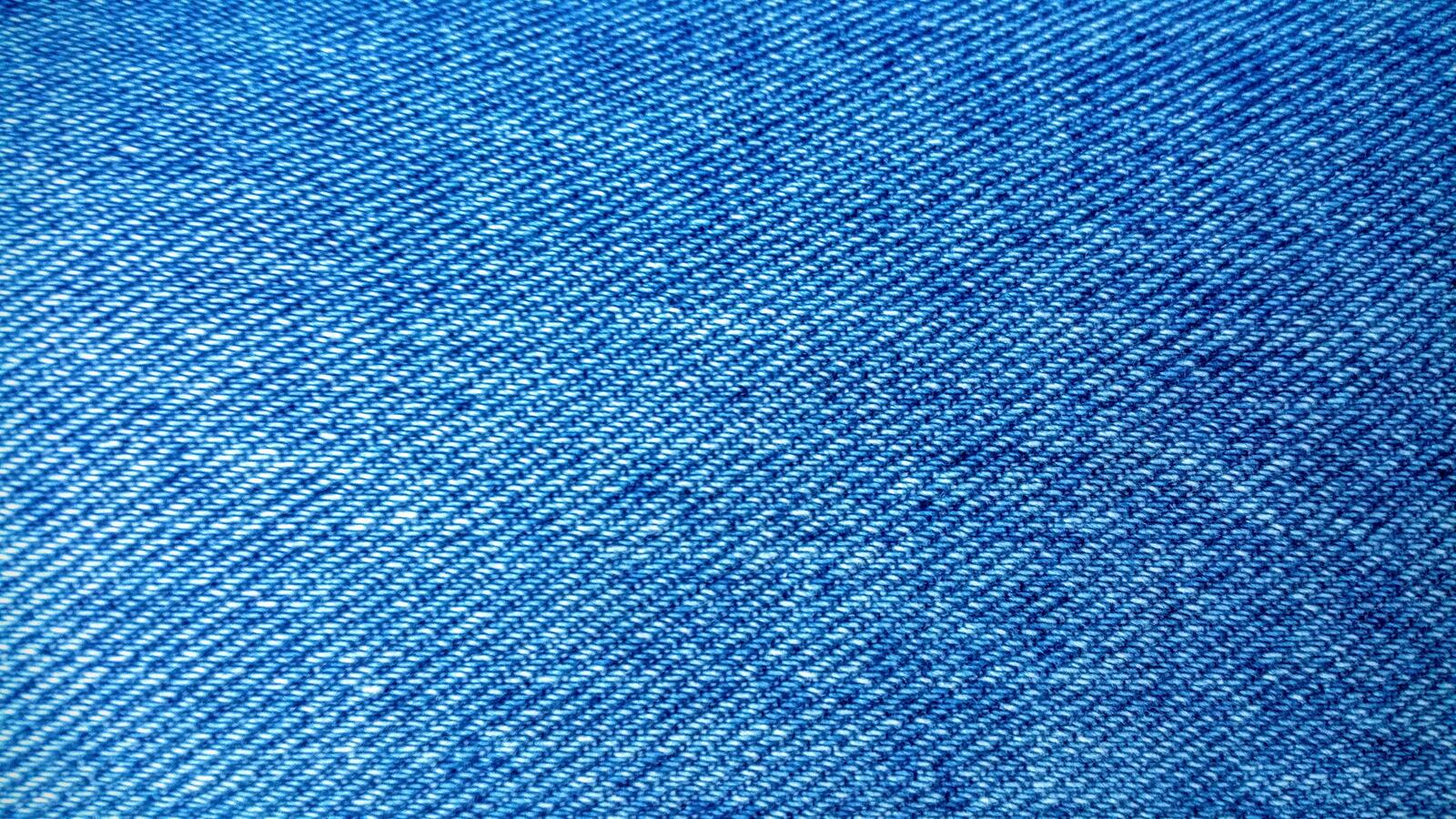 Бесплатное фото Голубая джинсовая ткань крупным планом