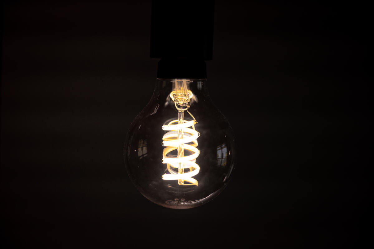 The incandescent filament in a light bulb