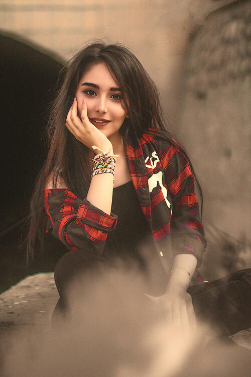 Beautiful dark-haired model in a plaid shirt