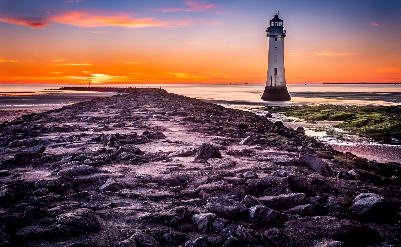 免费照片日落时分海边的灯塔