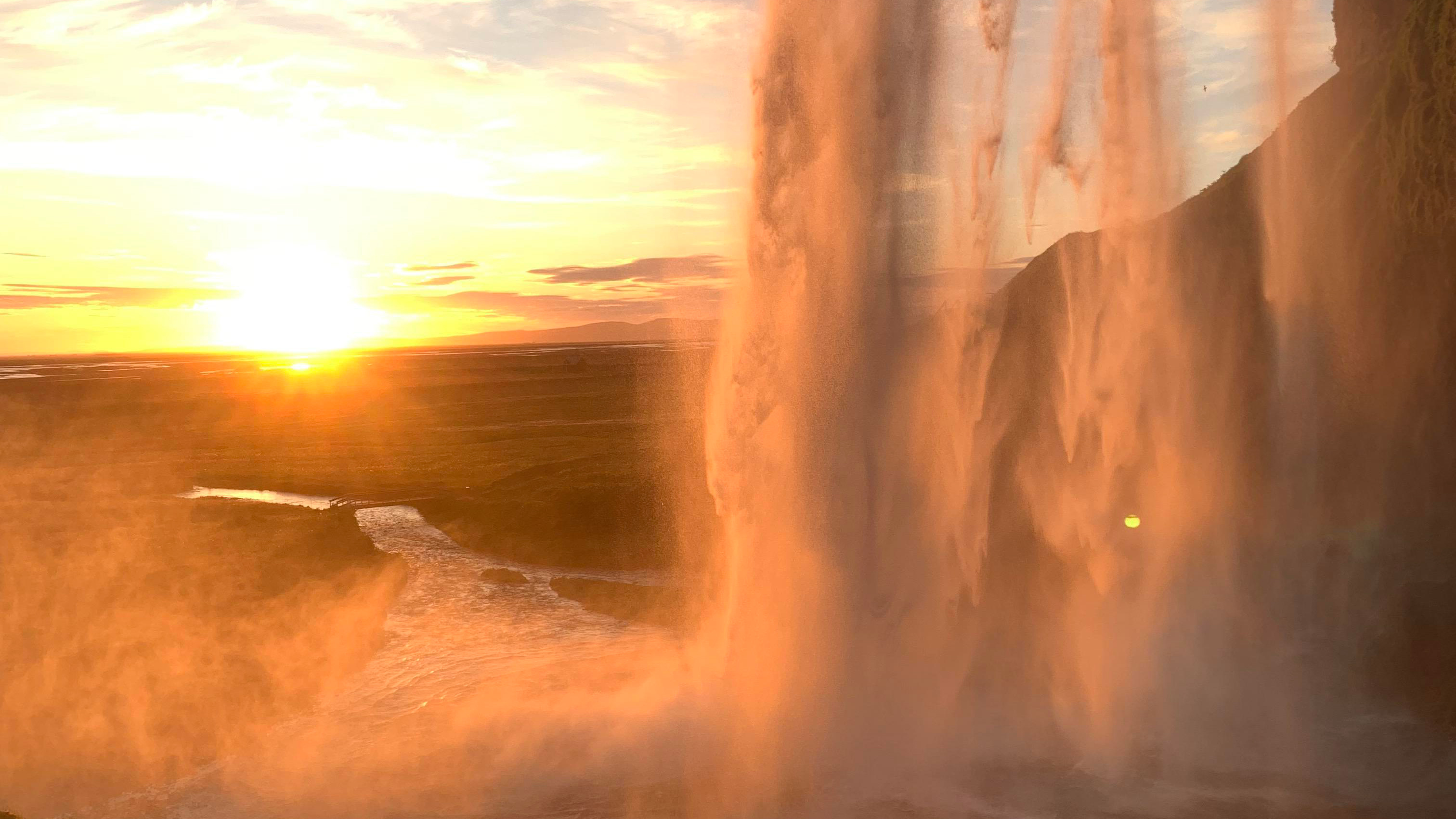 Falling water from the cliff at sunset