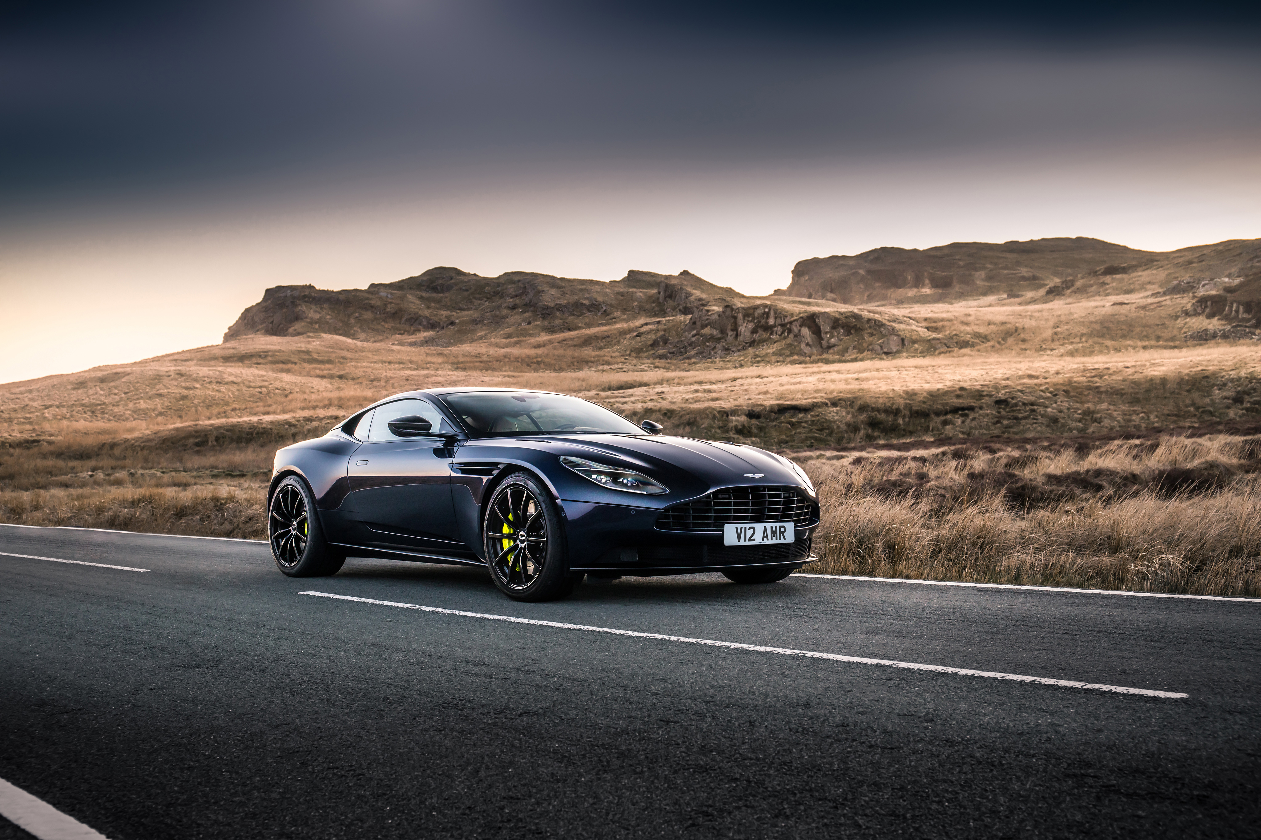 Free photo A picture of an Aston Martin DB11 on a country track.