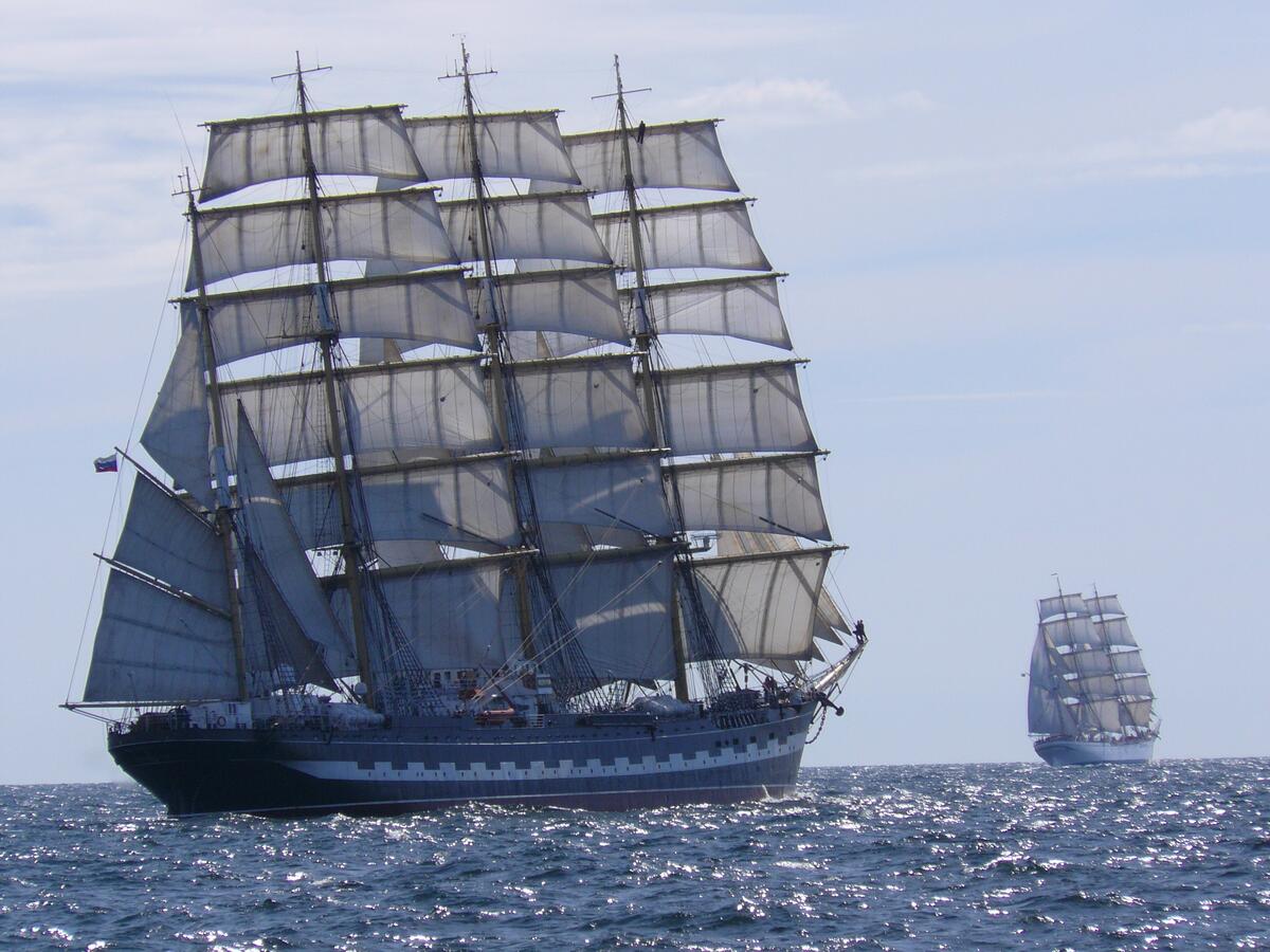 Two large sailing ships are sailing on the sea