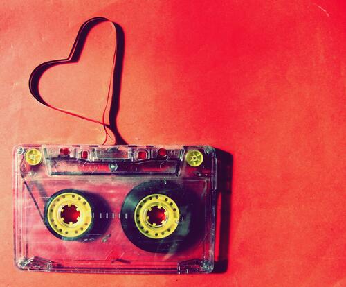 A cassette tape with a tangled heart-shaped tape.
