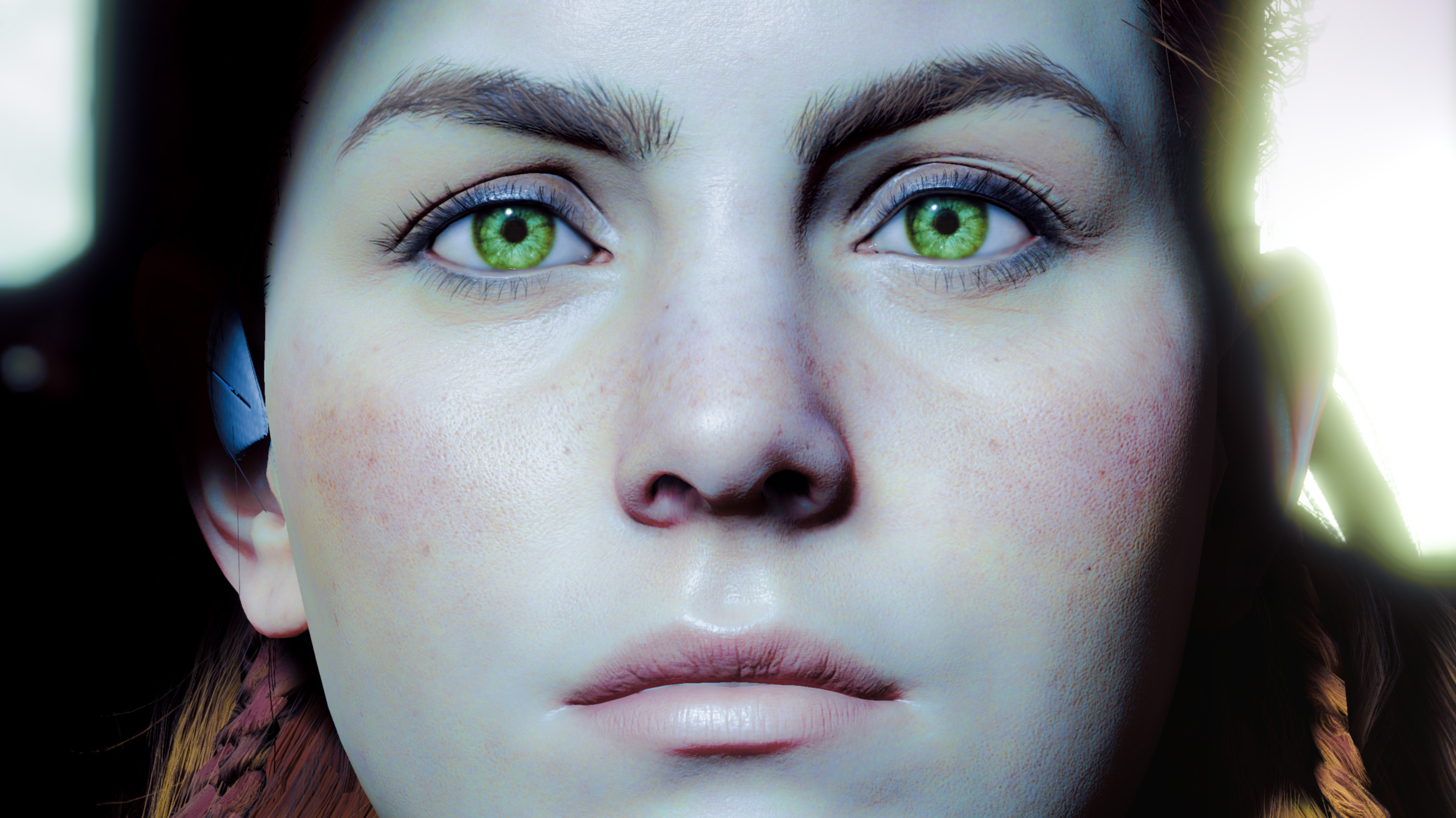 The face of a woman with bright green eyes