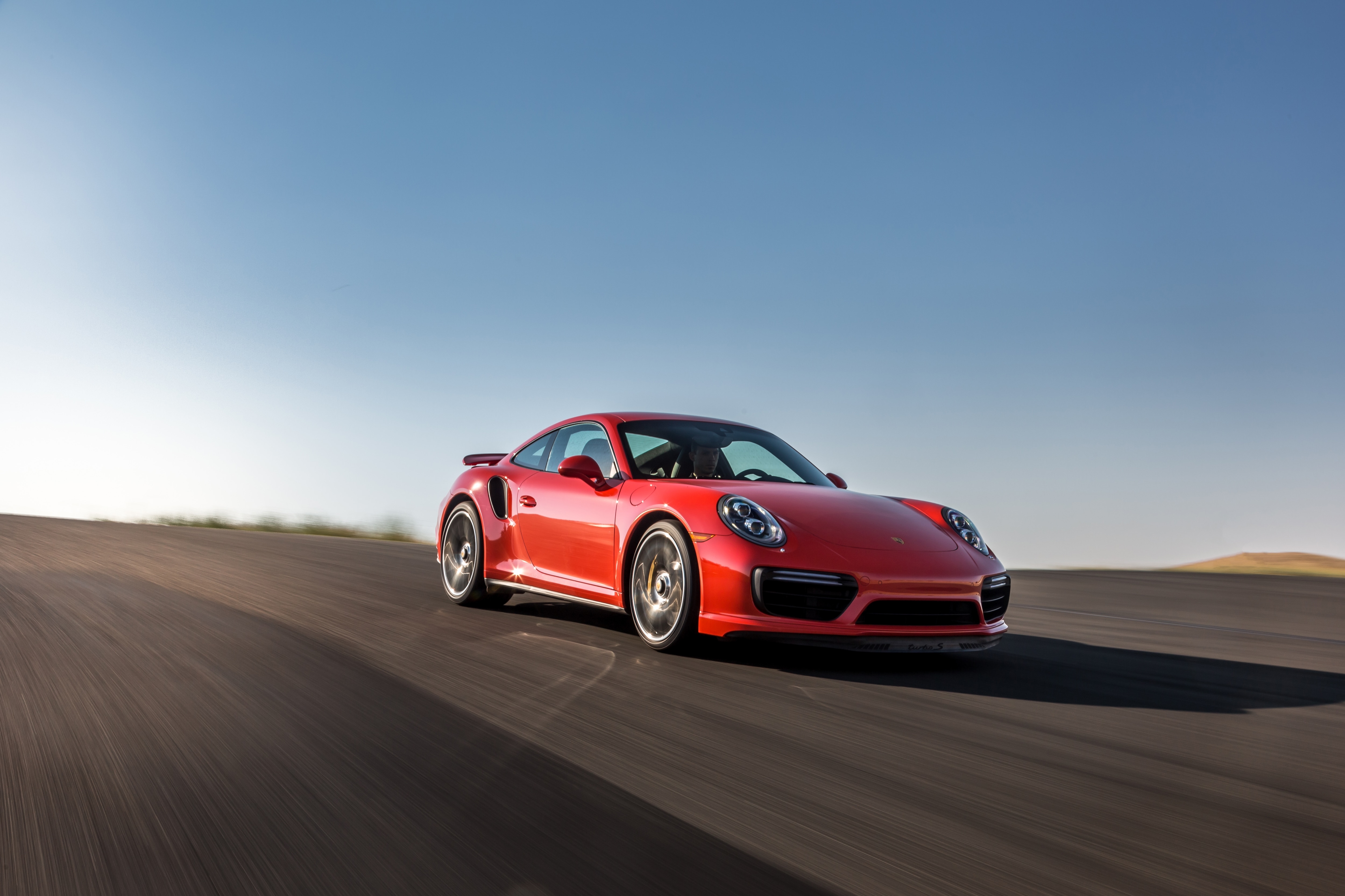 Desktop wallpaper with a red Porsche 911 in motion