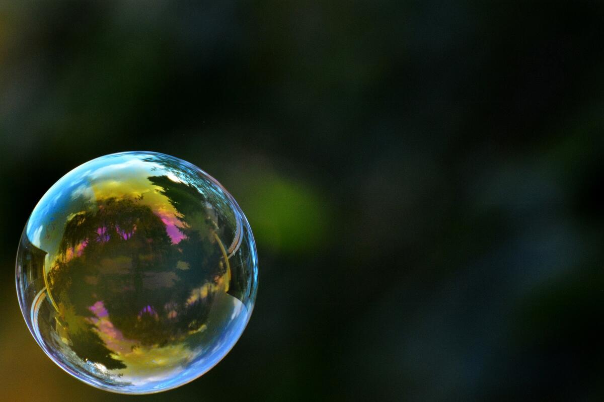 Мыльный пузырь на воздухе переливается различными цветами