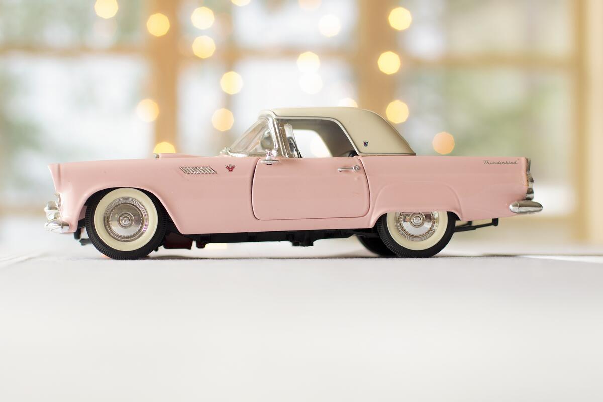 A toy of a small vintage retro car
