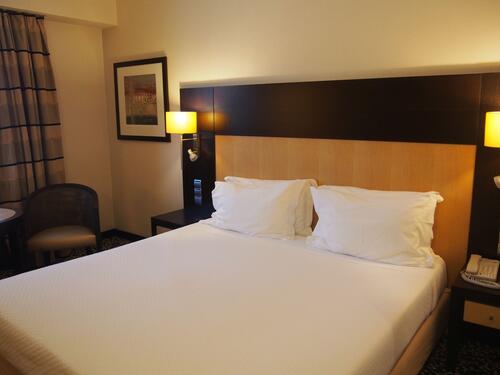 A large double bed in a spacious room
