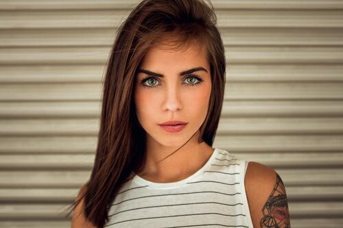 Beautiful brunette with a tattoo on her shoulder