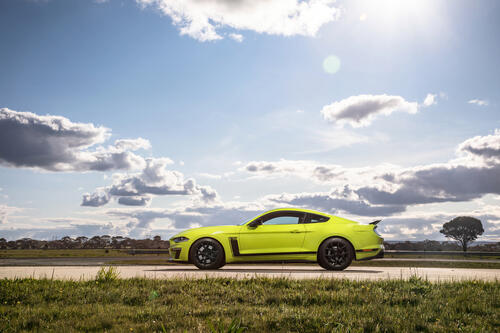 A bright green Ford Mustang in sunny weather