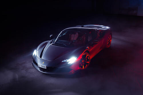 Ferrari sf90 stradale 2022 года с включенными фарами в темном помещении
