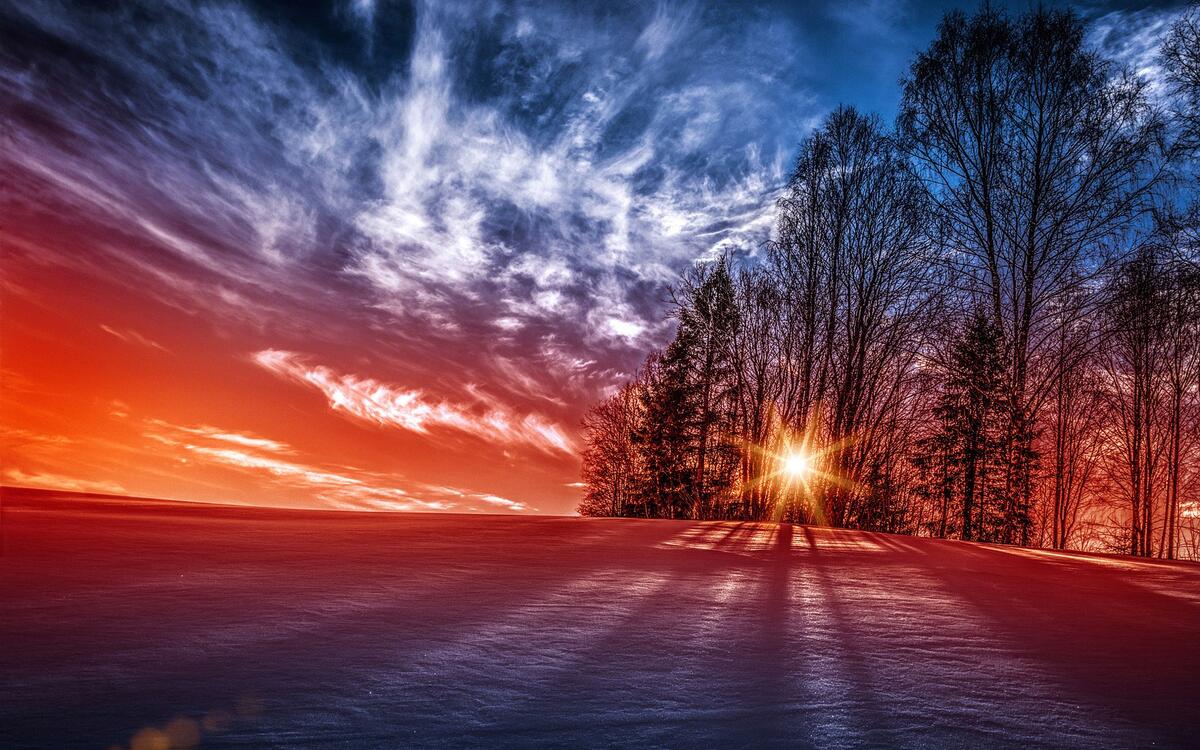A red sunset on a snowy field
