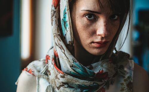 Portrait of a skin-skinned girl with a scarf on her head