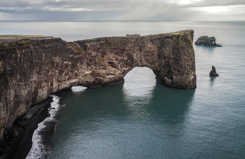 Large rock on the sea with an arch