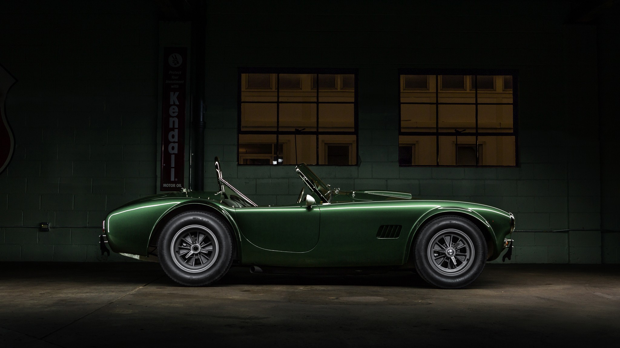 Green Shelby Cobra side view.