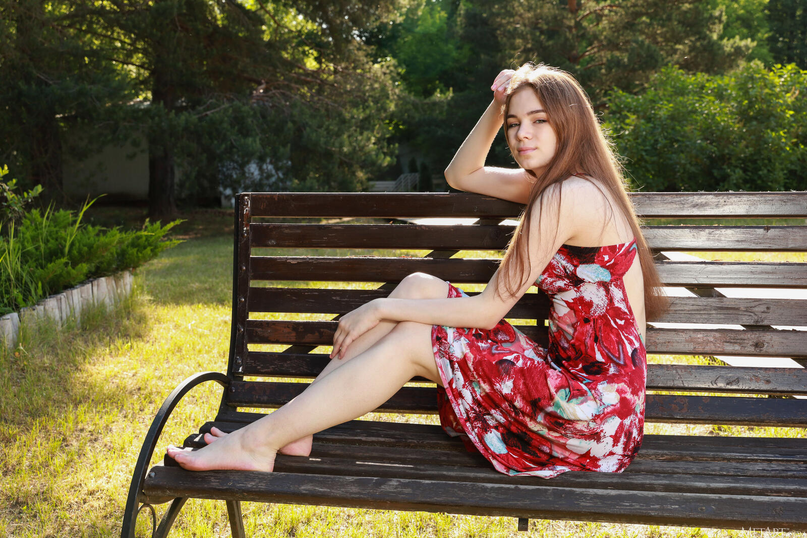 Free photo Beautiful girl in a dress on a bench