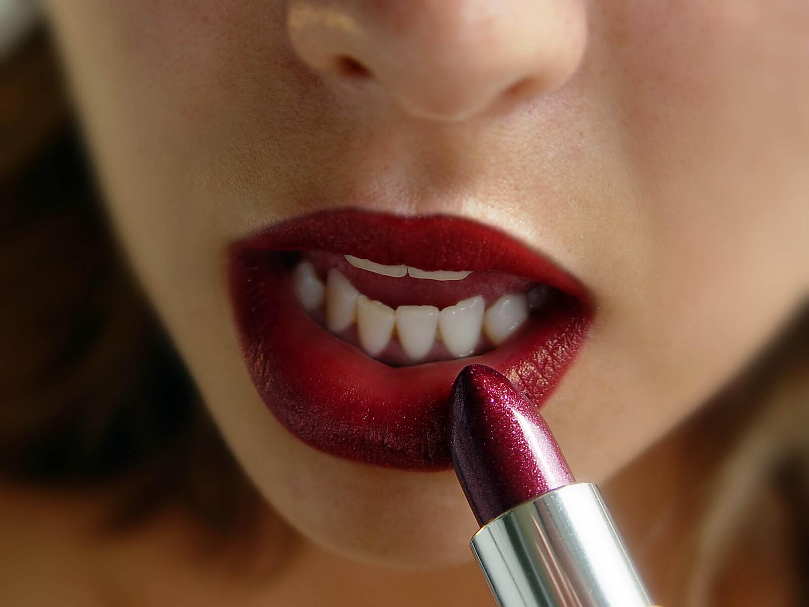 Free photo Red lipstick on a girl`s lips