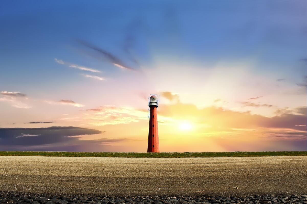 A lonely lighthouse at sunset