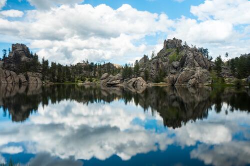 A lake in a rocky area reflects the sky