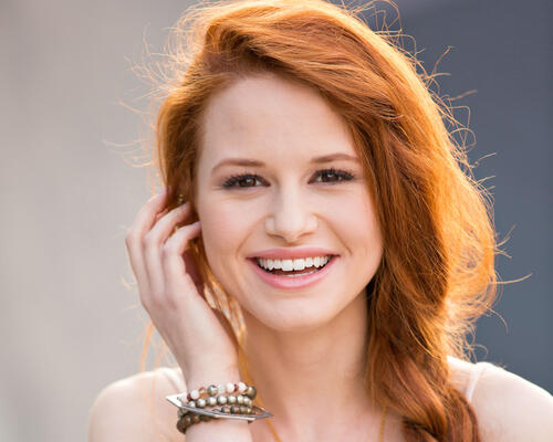 Madeline Petsch is a redheaded celebrity with a smile on her face