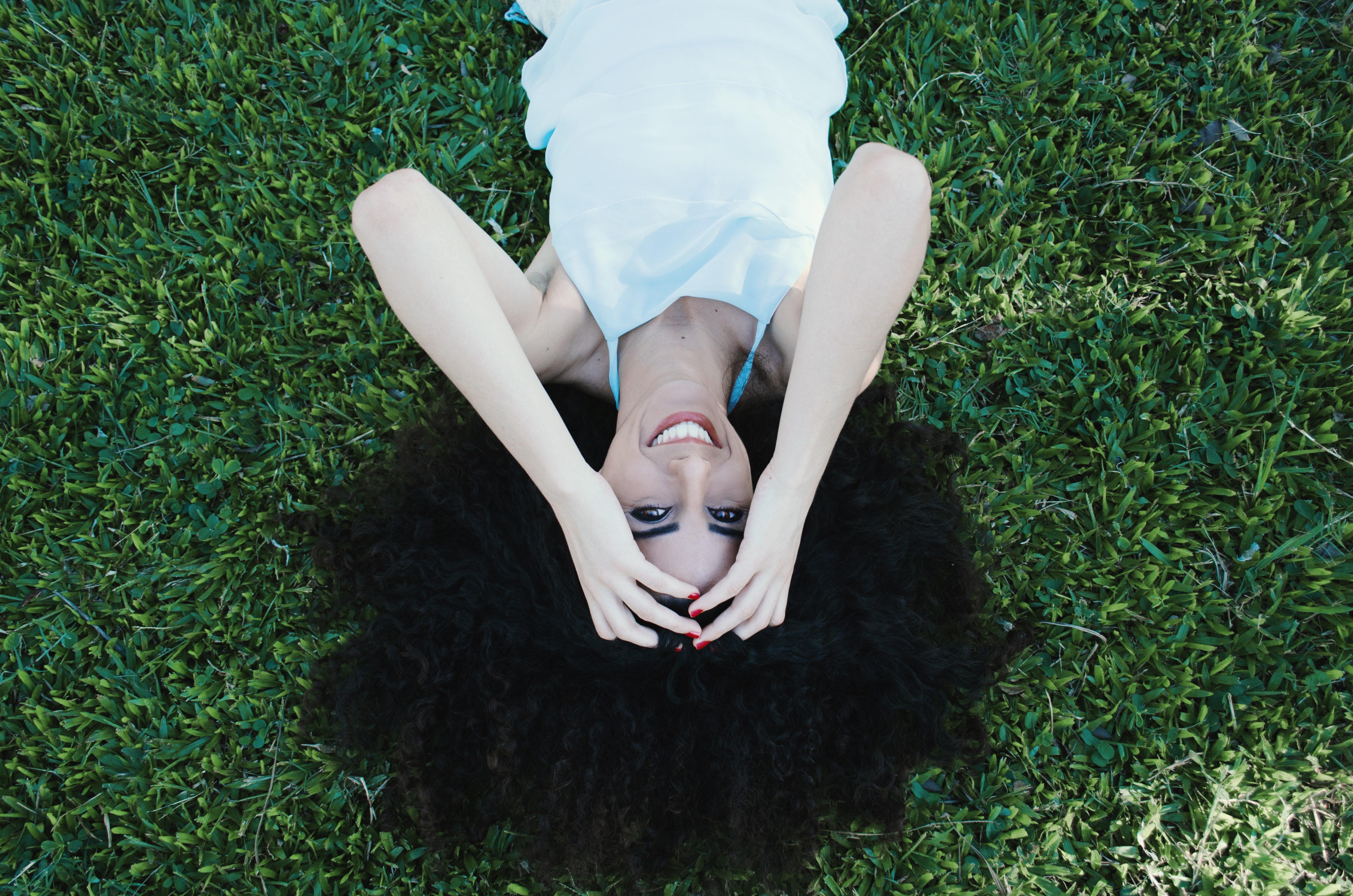 免费照片躺在草坪上的黑发美女